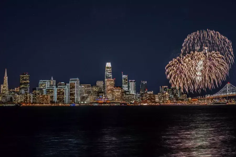 Fireworks explode over the San Francisco city skyline.